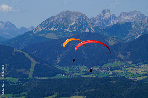 Obraz na płótnie two friends paragliding in the Alps of the Dachstein region in Austria