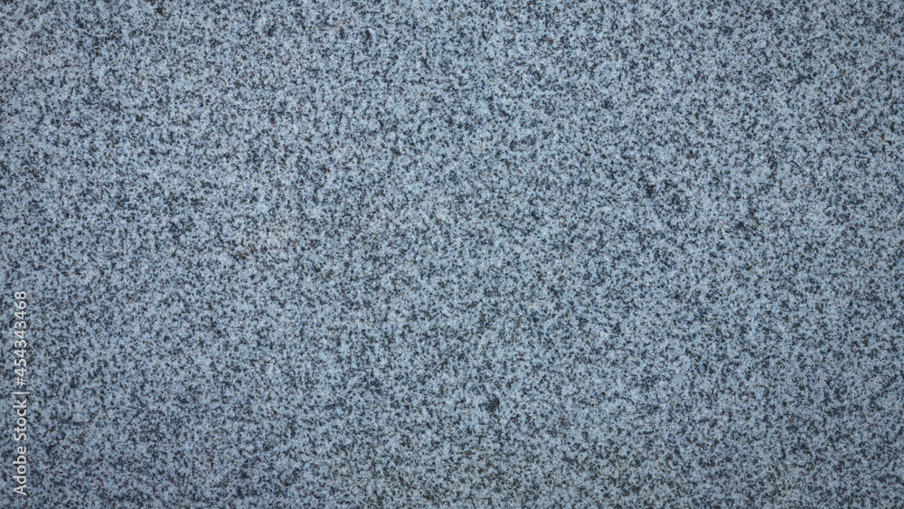 Gray blueish granite with black inclusions. Background granite texture, top view Gray blueish granite with black inclusions. Background granite texture, top view