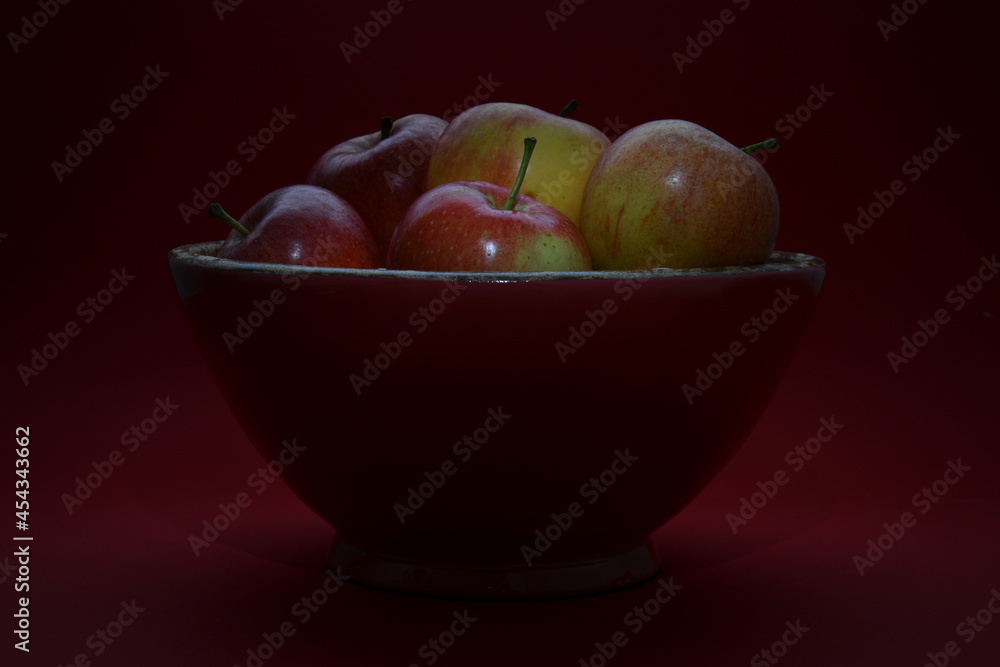 colorful bowl with green and red apples on a dark background colorful bowl with green and red apples on a dark background