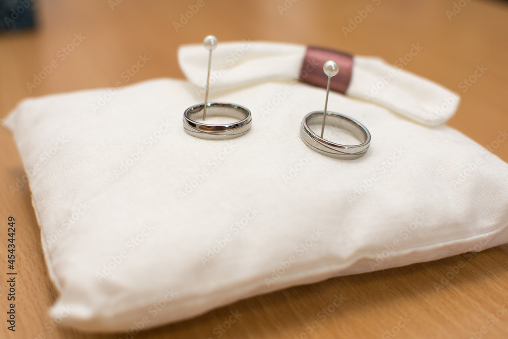 Two wedding rings made from white gold on pillow Two wedding rings made from white gold on pillow