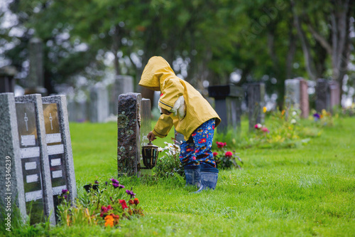 Photography Sad little child, blond boy, standing in the rain on cemetery, sad person, mourn