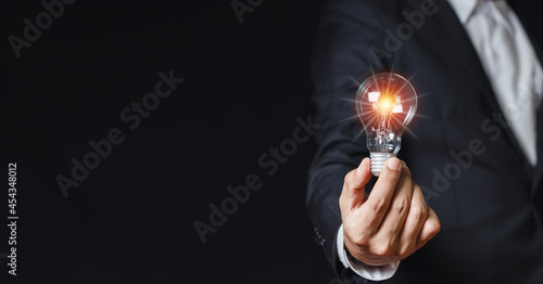 Businessman holding light bulbs. creative innovation. power vision and ideas concept.