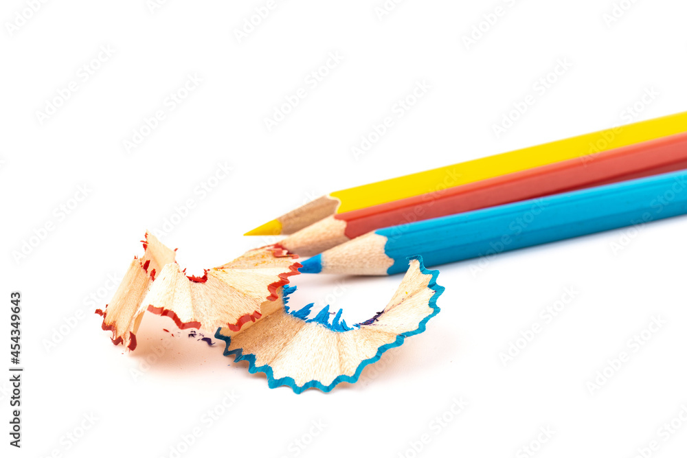 Wooden pencil whith shavings and colorful crumbs of graphite from sharpener. Back to school concept. Wooden pencil whith shavings and colorful crumbs of graphite from sharpener. Back to school concept.