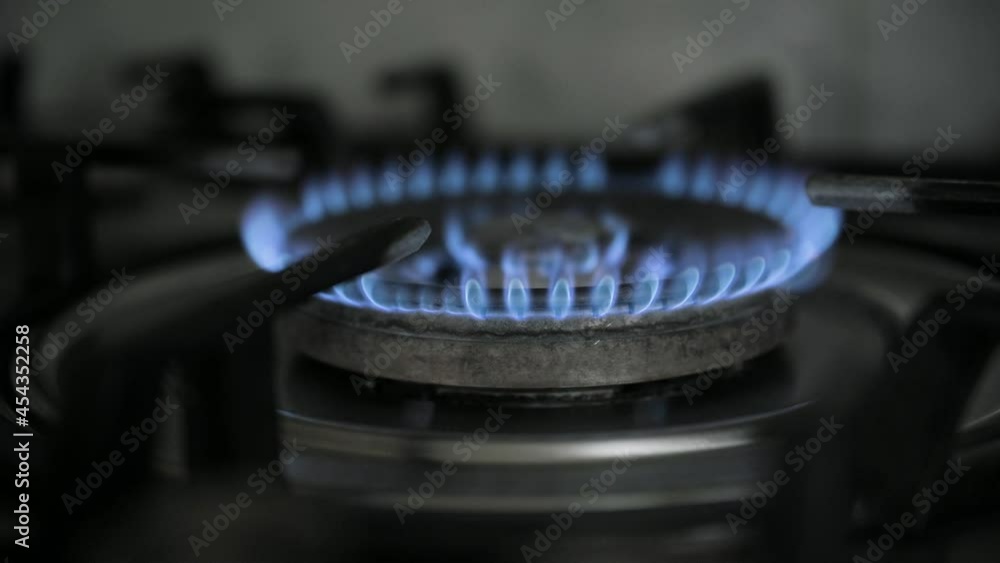 Gas cooker stove on home kitchen. Gas is switching on, apearing blue flame. UHD 4k video Gas cooker stove on home kitchen. Gas is switching on, apearing blue flame. UHD 4k video
