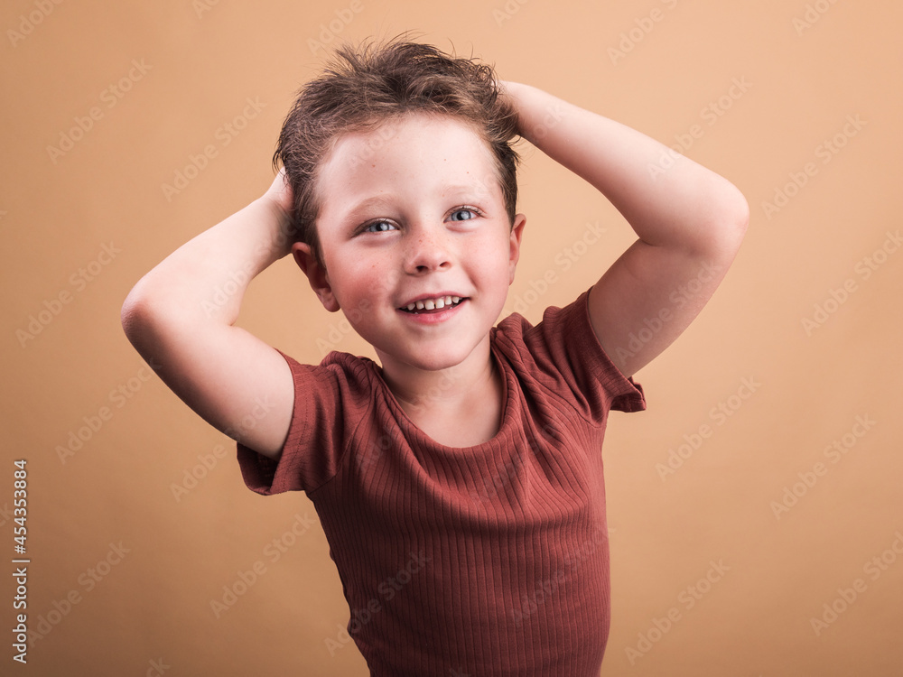 Smiling boy in t shirt on beige background Smiling boy in t shirt on beige background