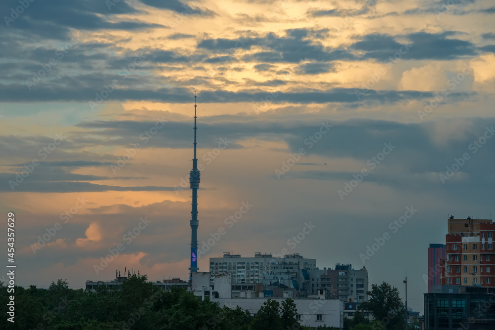 Sunset cloudy sky over the city of Moscow and the high spire of the Ostankino TV tower