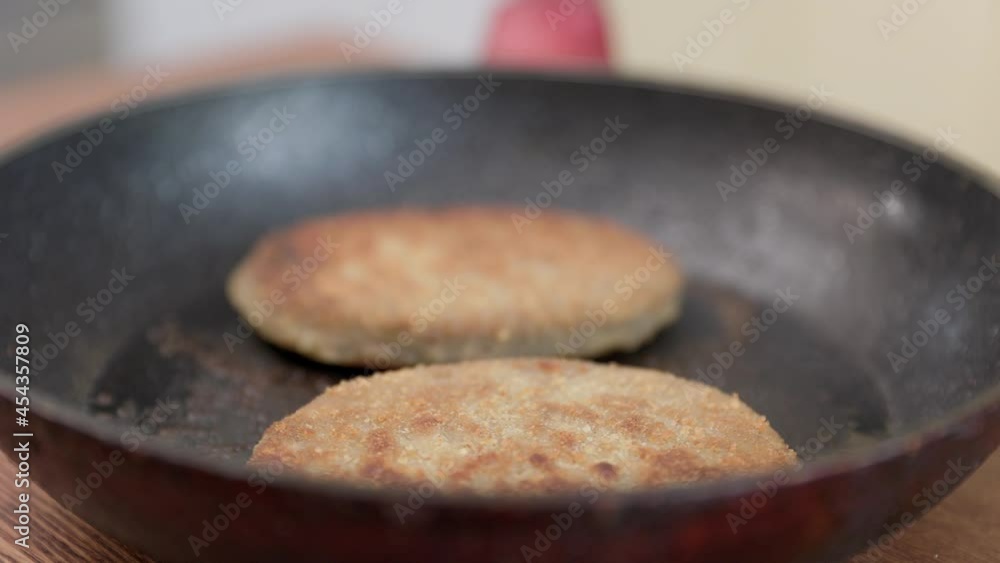 Fish cutlets in a frying pan with oil. The camera Moves Around the Table in the kitchen. Fish cutlets in a frying pan with oil. The camera Moves Around the Table in the kitchen.
