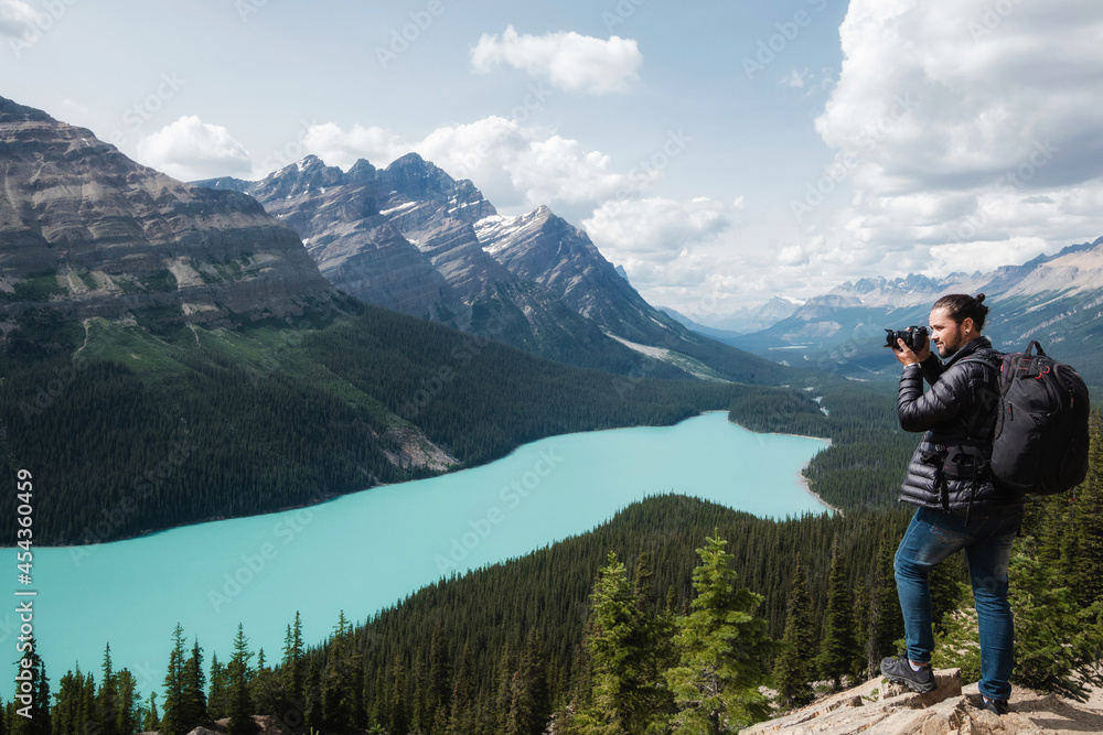 Landscape photographer at Peyto Lake during summer in Banff National Park, Alberta, Canada.