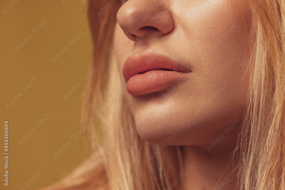 Cropped shot of face of young beautiful woman isolated over colored studio background. Natural beauty, wellness, healthy lifestyle, cosmetics concept. Cropped shot of face of young beautiful woman isolated over colored studio background. Natural beauty, wellness, healthy lifestyle, cosmetics concept.