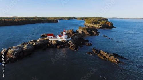 Drone appoaches the Head Harbour Lightstation in the summer, aerial footage of Campobello Island, New Brunswick, Canada