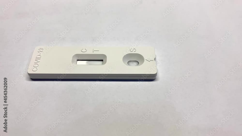 A COVID-19 antigen self test reagent on the table. After add drops of test sample into sample well, wait results interpretation. A COVID-19 antigen self test reagent on the table. After add drops of test sample into sample well, wait results interpretation.