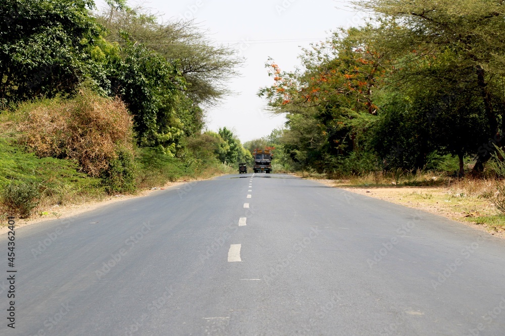 Rural Roads in India leading to the village at the distance Rural Roads in India leading to the village at the distance