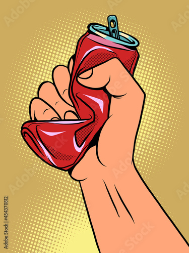 a hand crushes a tin can, the topic of ecology and garbage recycling. Container from the drink