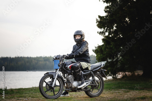 girl on a motorcycle in the open air. the way of life of a real person.