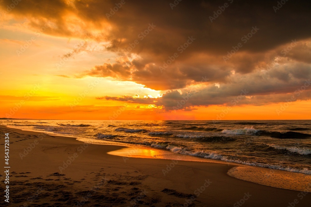 Beautiful sunset over a sandy seaside beach.