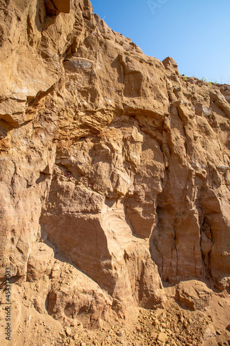 steep ravine slope, sandstone polished by wind and water erosion, stone texture