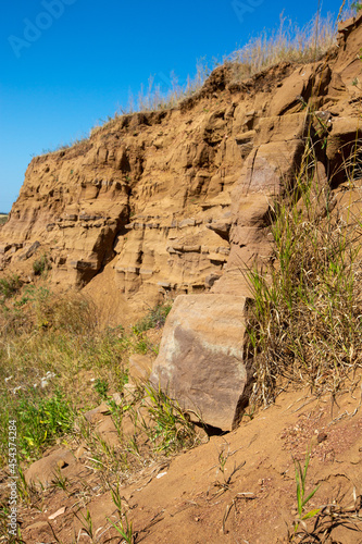 steep ravine slope, sandstone polished by wind and water erosion, stone texture