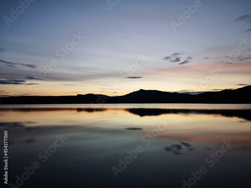 sunset over a mountain lake © ramund88