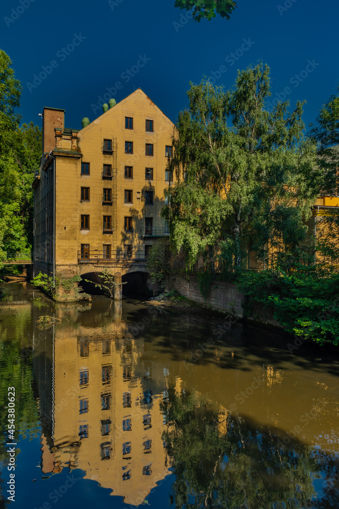 Old color big house mill in Litomerice town in north Bohemia in summer evening