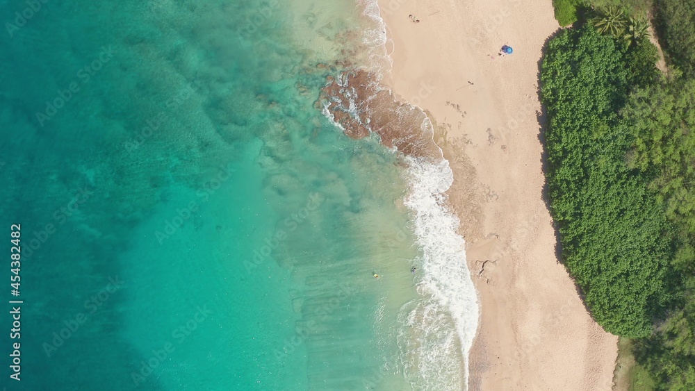 Aerial view from above down Drone shot. Beautiful tropical beach sea with white sand. Top view. Empty and clean beach in summer season on Oahu Hawaii Island. Aerial view from above down Drone shot. Beautiful tropical beach sea with white sand. Top view. Empty and clean beach in summer season on Oahu Hawaii Island.
