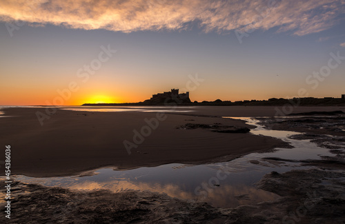 Wallpaper Mural The iconic Bamburgh Castle in Northumberland at sunrise, with the nearby beach deserted.
 Torontodigital.ca