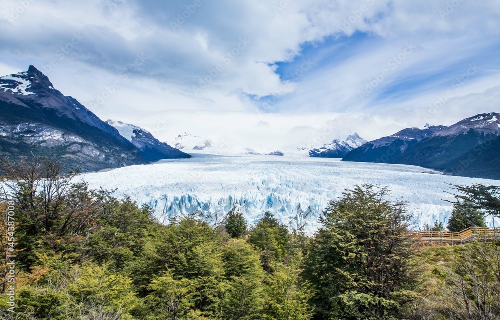 View of the Perito Moreno glacier with details of the iceberg and ice on a sunny day with clouds
