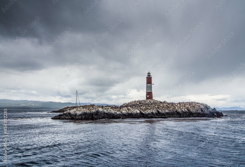 Marine lighthouse on a small island on a cold and cloudy day in Patagonia near Antarctica
