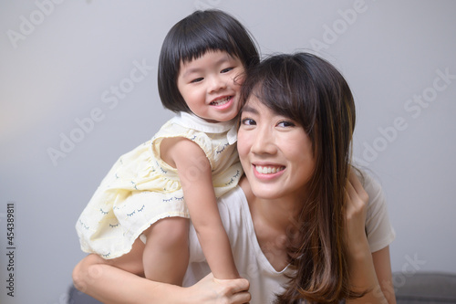 Portrait of happy asian mom and daughter