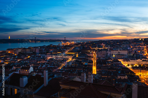 Scenic panoramic view of the downtown of the city of Lisbon at sunset  with the Tagus River on the background  in Portugal.
