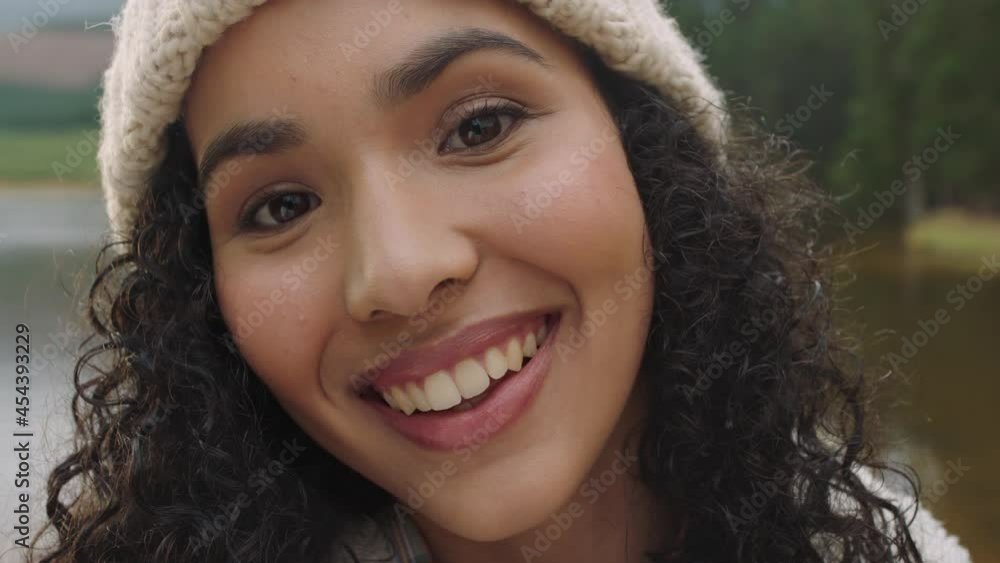 close up portrait beautiful mixed race woman smiling looking happy wearing beanie enjoying cold winter outdoors in nature by lake real people 4k close up portrait beautiful mixed race woman smiling looking happy wearing beanie enjoying cold winter outdoors in nature by lake real people 4k