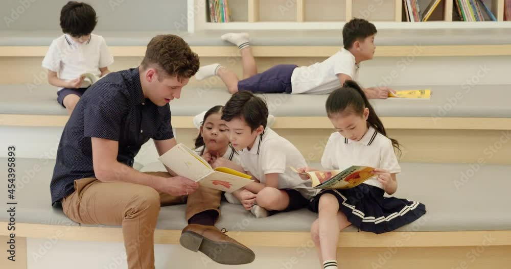 Foreign teacher and children reading book in library,4K Foreign teacher and children reading book in library,4K
