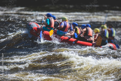 Raft boat during whitewater rafting extreme water sports on water rapids, kayaking and canoeing on the river, water sports team with a big splash of water