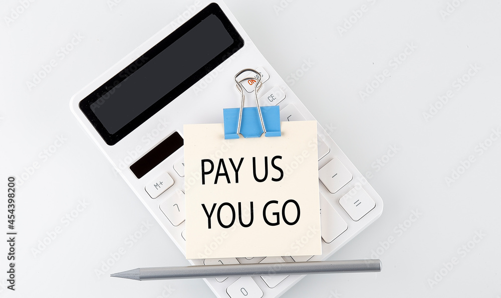 PAY AS YOU GO text on the sticker on white calculator PAY AS YOU GO text on the sticker on white calculator