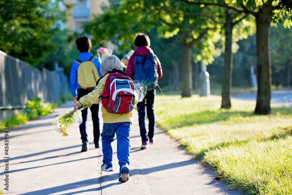 Happy children, going to school in the morning, first day, caring bouquet of flowers for the teacher Happy children, going to school in the morning, first day, caring bouquet of flowers for the teacher