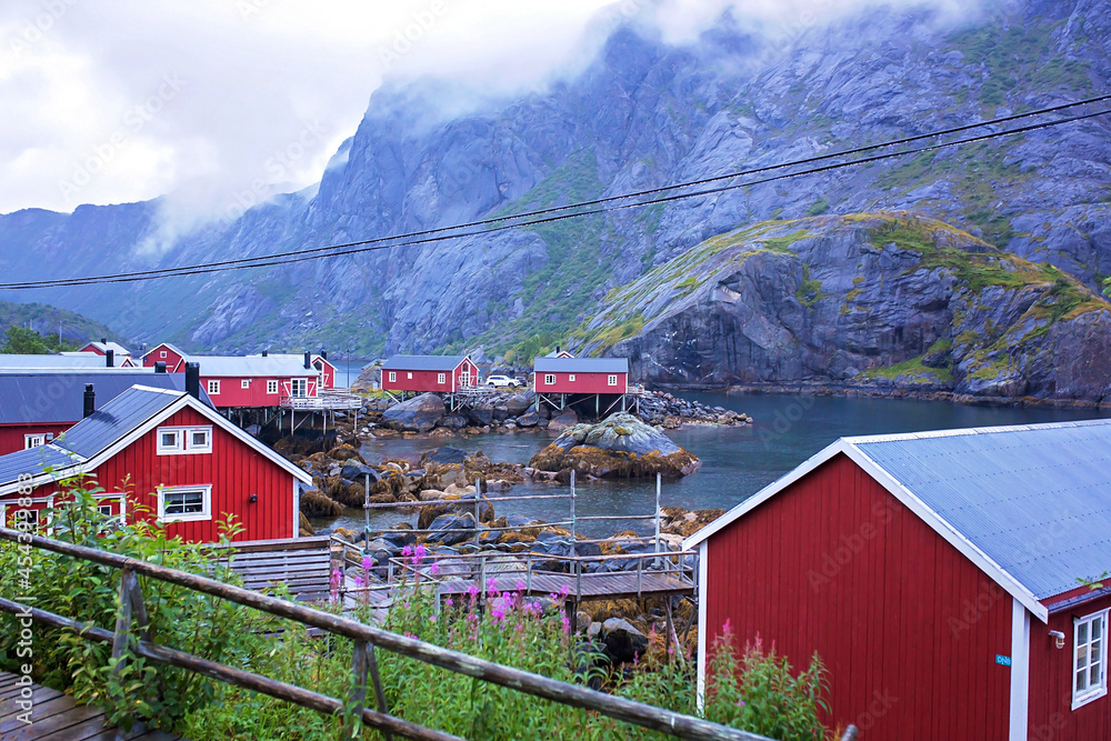 Typical Rourbuer fishing cabins in Lofoten Nusfjord village on a rainy day, summertime. Traditional norwegian wooden house