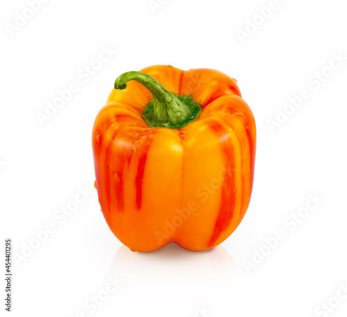 Orange sweet pepper isolated on white with shadow and reflection. Vertically.