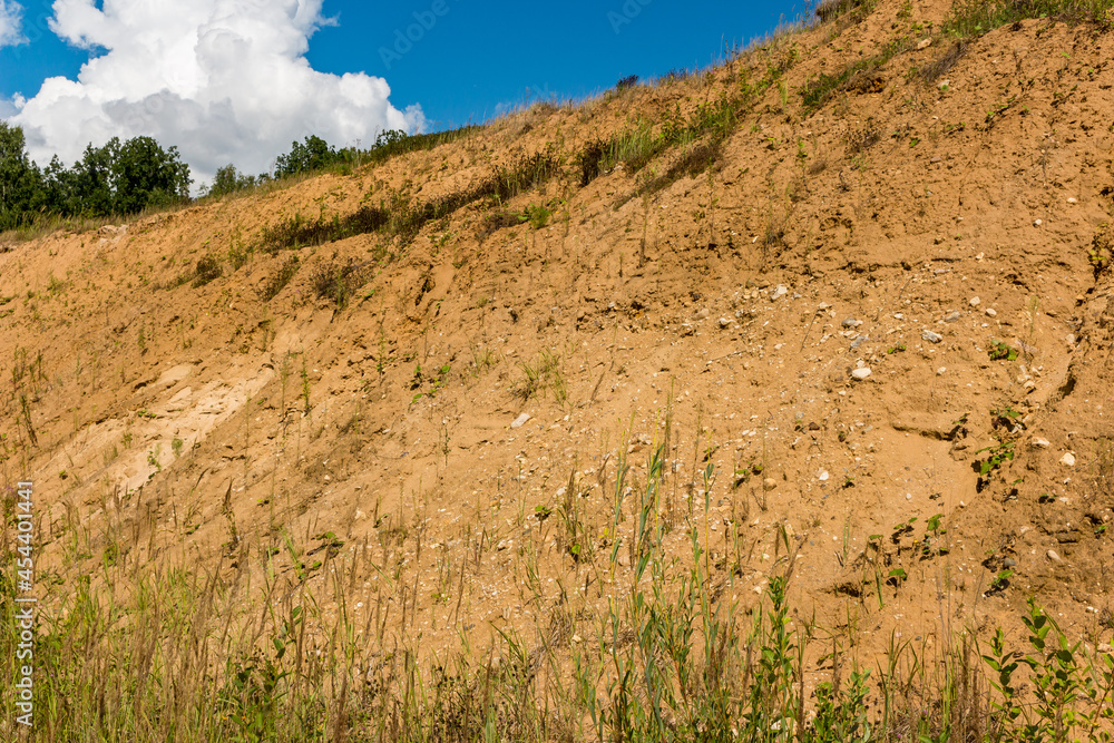 Fototapeta premium Sandy slope several meters high, the edge of a sand pit
