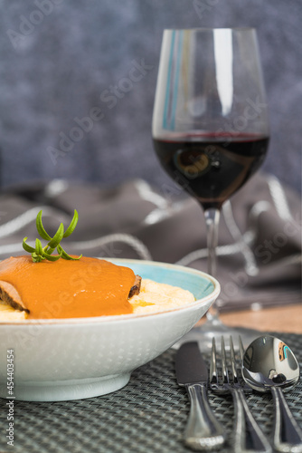 Vertical photo of a dish with cornflour with roasted beef covered with sauce