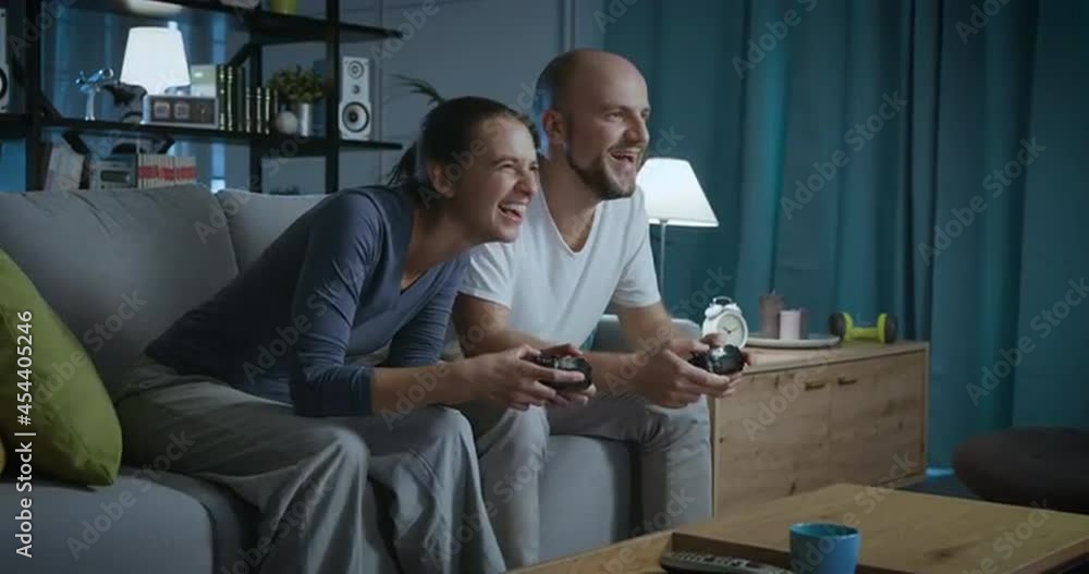 Couple playing video games together Couple playing video games together