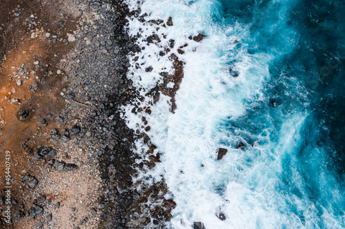 Top Down Aerial Shot of Waves Crashing on Rocks in the Caribbean