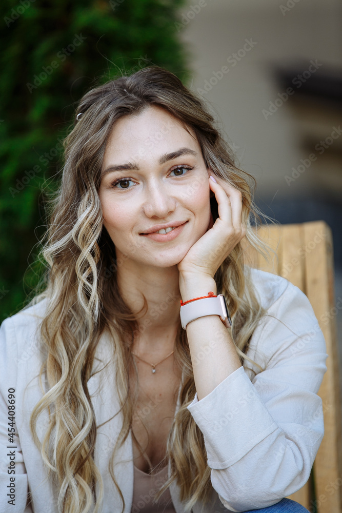 portrait of happy woman on blurred city background
