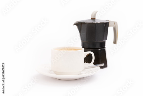 Moka coffee maker on white background and a mug