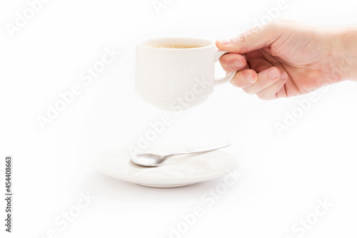 Coffee mug on a white background and a spoon