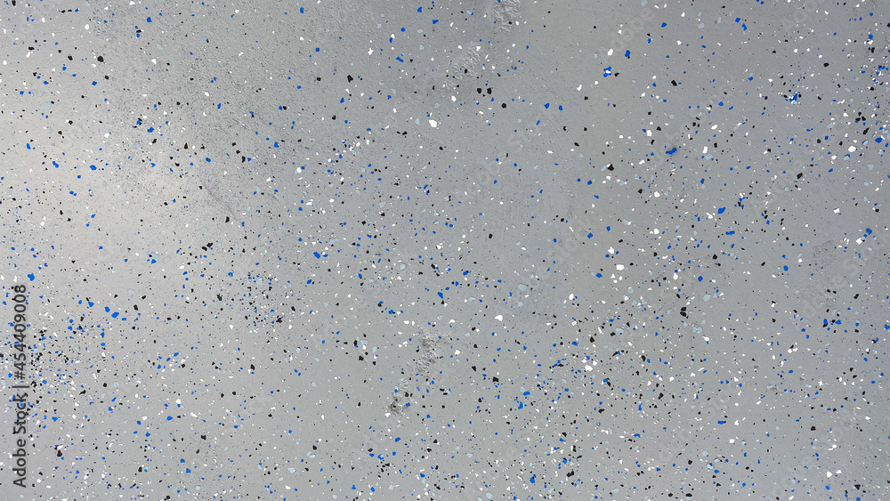 A freshly painted with a gray epoxy finish sprinkled with blue, black and white plastic chips. A freshly painted with a gray epoxy finish sprinkled with blue, black and white plastic chips.