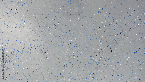 A freshly painted with a gray epoxy finish sprinkled with blue, black and white plastic chips.