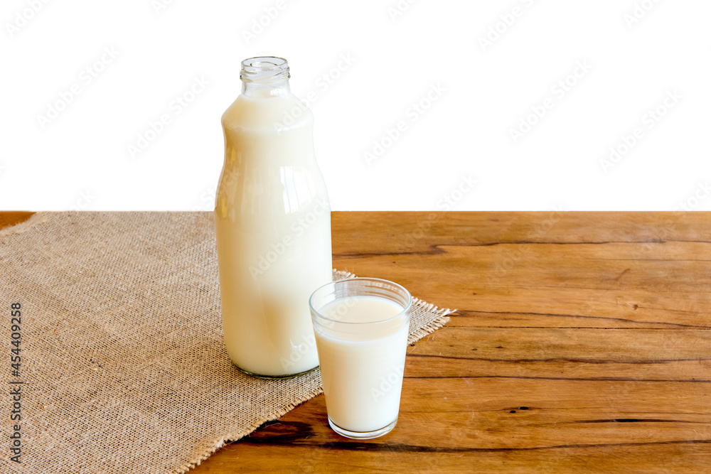 bottle and glass of milk on wooden table with white background. bottle and glass of milk on wooden table with white background.