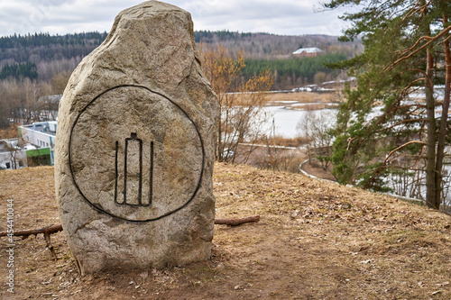 Stone on the hill with an Lithuanian old historical symbol on it.  photo