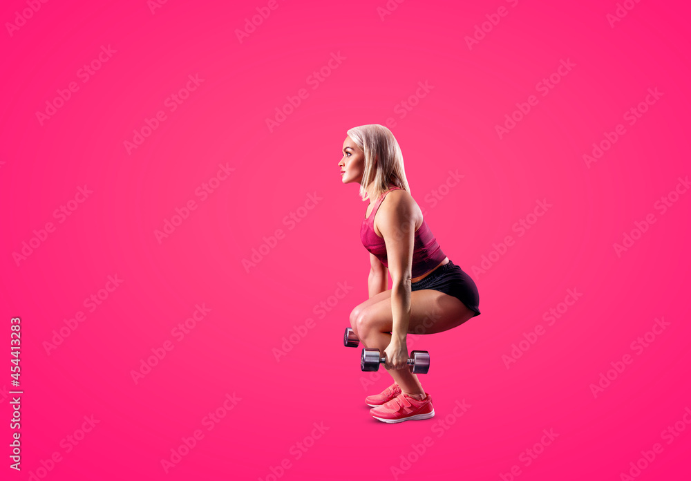 Young woman doing squats with a dumbbells.