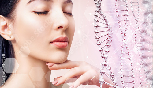 Beautiful sensual woman and glass DNA stems over pink background. photo