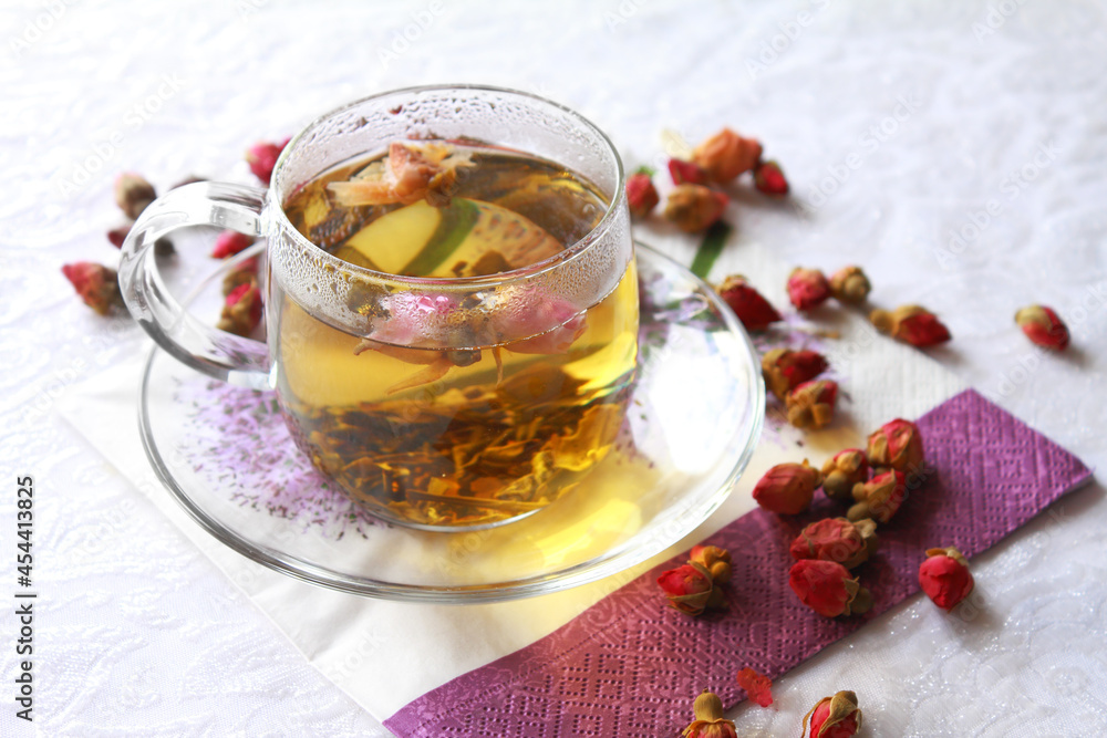 Glass transparent cup of green tea with rosebuds Glass transparent cup of green tea with rosebuds